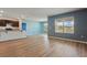 Open-concept living room with modern flooring and plenty of natural light overlooking a lake at 3348 Perennial Ln, Kissimmee, FL 34746