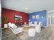 Bright living room with modern white furniture, contemporary decor, and a large entertainment center at 3348 Perennial Ln, Kissimmee, FL 34746