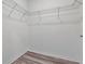 Walk-in closet featuring wire shelving and wood-look floors at 3348 Perennial Ln, Kissimmee, FL 34746