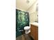 Bathroom featuring a shower with decorative rainforest curtain and a light wood vanity at 339 Sigmund Loop, Davenport, FL 33837