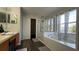 Bright bathroom with separate tub and shower, linen closet and wood look floors at 339 Sigmund Loop, Davenport, FL 33837