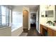 Bright bathroom with separate tub and shower, linen closet and wood look floors at 339 Sigmund Loop, Davenport, FL 33837