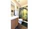 Well-lit bathroom features a vanity, mirror, toilet, and shower with forest curtain at 339 Sigmund Loop, Davenport, FL 33837