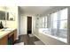 Bright bathroom with separate tub and shower, linen closet and wood look floors at 339 Sigmund Loop, Davenport, FL 33837