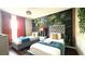 Bedroom with two beds, decorative wallpaper and great natural light from the window at 339 Sigmund Loop, Davenport, FL 33837