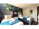 Bedroom with two beds, decorative wallpaper, a walk-in closet and a TV on a dresser at 339 Sigmund Loop, Davenport, FL 33837