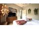 Stylish bedroom boasts a dresser, TV, foliage, and view to the hallway at 339 Sigmund Loop, Davenport, FL 33837