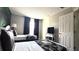 Bedroom with two beds, decorative wallpaper, dark curtains and a dresser with a TV at 339 Sigmund Loop, Davenport, FL 33837