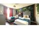 Bedroom with two beds, decorative wallpaper, natural light, and a hanging plant at 339 Sigmund Loop, Davenport, FL 33837