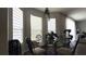 Sunlit breakfast nook includes a modern glass table, shuttered windows and natural decor at 339 Sigmund Loop, Davenport, FL 33837