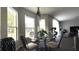 Cozy dining area featuring a glass table, modern chairs, and natural lighting, perfect for Gathering meals and gatherings at 339 Sigmund Loop, Davenport, FL 33837