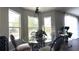 Cozy dining area featuring a glass table, modern chairs, and natural lighting, perfect for Gathering meals and gatherings at 339 Sigmund Loop, Davenport, FL 33837