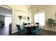 Elegant dining room with stylish chandelier, sophisticated decor, and plenty of space for entertaining guests at 339 Sigmund Loop, Davenport, FL 33837