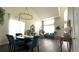 A dining room features high ceilings, contemporary chandelier, modern furniture, and plenty of natural light at 339 Sigmund Loop, Davenport, FL 33837