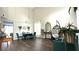 The elegant dining room features high ceilings, contemporary chandelier, modern furniture, and lots of natural light at 339 Sigmund Loop, Davenport, FL 33837
