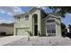 Charming two-story home with an arched entryway and manicured, low-maintenance landscaping at 339 Sigmund Loop, Davenport, FL 33837