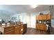 Open concept kitchen boasts granite counters, wood cabinets, and stainless dishwasher at 339 Sigmund Loop, Davenport, FL 33837