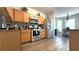 Open kitchen features stainless appliances, wood cabinets and flows into breakfast nook at 339 Sigmund Loop, Davenport, FL 33837