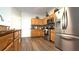 Well-lit kitchen boasts stainless steel appliances, wood cabinets, and modern backsplash at 339 Sigmund Loop, Davenport, FL 33837