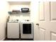 Convenient laundry room with washer, dryer, wire rack, and ample shelving for storage at 339 Sigmund Loop, Davenport, FL 33837