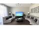 The living room features modern sofas, stylish tables, and plenty of space for relaxing or entertaining guests at 339 Sigmund Loop, Davenport, FL 33837
