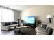 Inviting living room with modern sofas, stylish tables, entertainment center, and a relaxing space for guests at 339 Sigmund Loop, Davenport, FL 33837