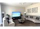 A cozy living room features modern sofas, stylish tables, and plenty of space for relaxing and entertaining guests at 339 Sigmund Loop, Davenport, FL 33837