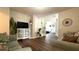 Comfortable living room featuring hardwood floors, a display cabinet and an open doorway at 339 Sigmund Loop, Davenport, FL 33837