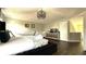 Bright main bedroom featuring dark wood floors, a king bed and a crib at 339 Sigmund Loop, Davenport, FL 33837