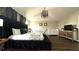 Bright main bedroom featuring dark wood floors, a king bed and a crib at 339 Sigmund Loop, Davenport, FL 33837