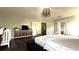Bright main bedroom featuring dark wood floors, a king bed, crib and TV at 339 Sigmund Loop, Davenport, FL 33837