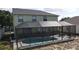 A screened-in pool with an outdoor dining area in a well-maintained backyard at 339 Sigmund Loop, Davenport, FL 33837