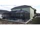 Backyard screened-in pool area with an outdoor dining set and well-maintained landscaping at 339 Sigmund Loop, Davenport, FL 33837