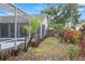 Landscaped backyard featuring a screened pool, beautiful plants, and an outdoor kitchen area, ideal for outdoor living at 4353 Steed Ter, Winter Park, FL 32792