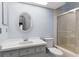Bathroom featuring a single vanity, round mirror, toilet, and tiled walk-in shower at 4353 Steed Ter, Winter Park, FL 32792