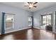 Bedroom with wood flooring, large windows, and access to a screened-in patio at 4353 Steed Ter, Winter Park, FL 32792