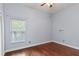 Bedroom with hardwood floors, a window with blinds, and a neutral color scheme at 4353 Steed Ter, Winter Park, FL 32792