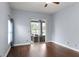 Bedroom features wood flooring, and sliding glass door access to screened-in patio at 4353 Steed Ter, Winter Park, FL 32792