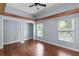 Bright bedroom with hardwood floors, wooden beams and two windows bringing in natural light at 4353 Steed Ter, Winter Park, FL 32792