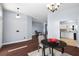 Dining room with dark wood floors, modern chandelier, and open access to other rooms at 4353 Steed Ter, Winter Park, FL 32792