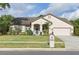 Charming home with a manicured front lawn, mature landscaping, and a two-car garage, offering curb appeal and functionality at 4353 Steed Ter, Winter Park, FL 32792