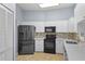 Modern kitchen with stainless steel appliances, white cabinets, and updated countertops at 4353 Steed Ter, Winter Park, FL 32792