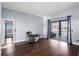 Spacious room with dark wood floors, chair, and sliding glass doors to the pool area at 4353 Steed Ter, Winter Park, FL 32792