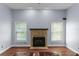 Living room featuring a cozy fireplace and natural light from nearby windows at 4353 Steed Ter, Winter Park, FL 32792