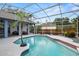 Inviting screened-in pool area with a custom pool and a covered lounge, perfect for outdoor relaxation and entertaining at 4353 Steed Ter, Winter Park, FL 32792