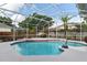 Sparkling swimming pool inside screened enclosure, surrounded by tropical plants at 4353 Steed Ter, Winter Park, FL 32792