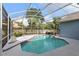 Relaxing screened pool featuring a uniquely shaped pool, tile trim, and a peaceful view of the surrounding greenery at 4353 Steed Ter, Winter Park, FL 32792