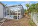 Screened pool in backyard offering privacy and relaxation; view of pool, surrounding deck, tropical plants, and yard at 4353 Steed Ter, Winter Park, FL 32792