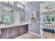 Bright bathroom featuring double vanity, modern lighting, and seamless access to an airy bedroom at 8340 Laureate Blvd, Orlando, FL 32827