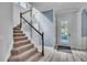 Inviting entryway showcasing a staircase with dark wood railings and a bright, welcoming entrance door at 8340 Laureate Blvd, Orlando, FL 32827